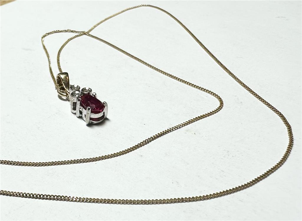 9ct yellow gold chain with a diamond pendant, showcasing a delicate design and sparkling gemstone on a white background.