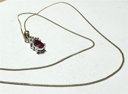9ct yellow gold chain with a diamond pendant, showcasing a delicate design and sparkling gemstone on a white background.