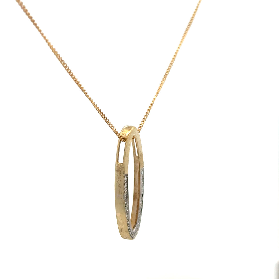 9ct yellow gold chain with diamond pendant, showcasing a delicate design and sparkling gemstones on a plain background.