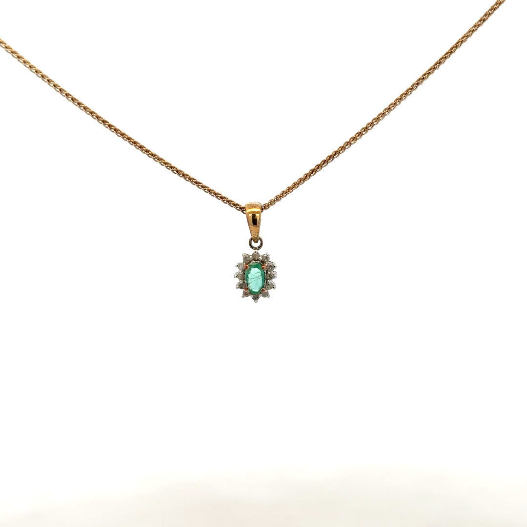 9ct yellow gold chain with emerald and diamond pendant, showcasing a delicate jewelry piece with vibrant green and sparkling stones.