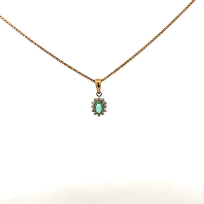 9ct yellow gold chain with emerald and diamond pendant, showcasing a delicate jewelry piece with vibrant green and sparkling stones.