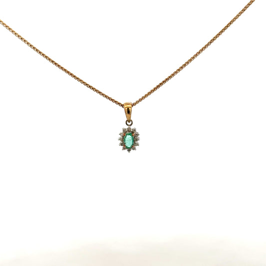 9ct yellow gold chain with emerald and diamond pendant, showcasing a delicate jewelry piece with vibrant green and sparkling stones.