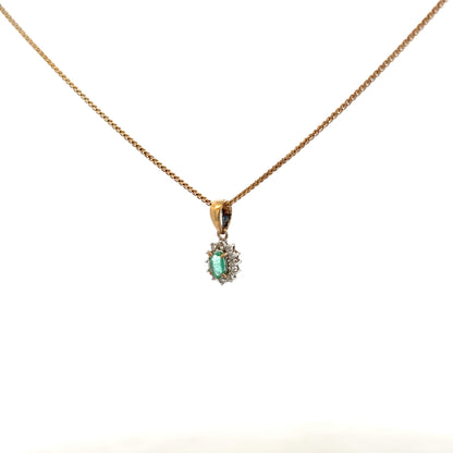 9ct yellow gold chain with emerald and diamond pendant, showcasing a delicate design and vibrant gemstones.