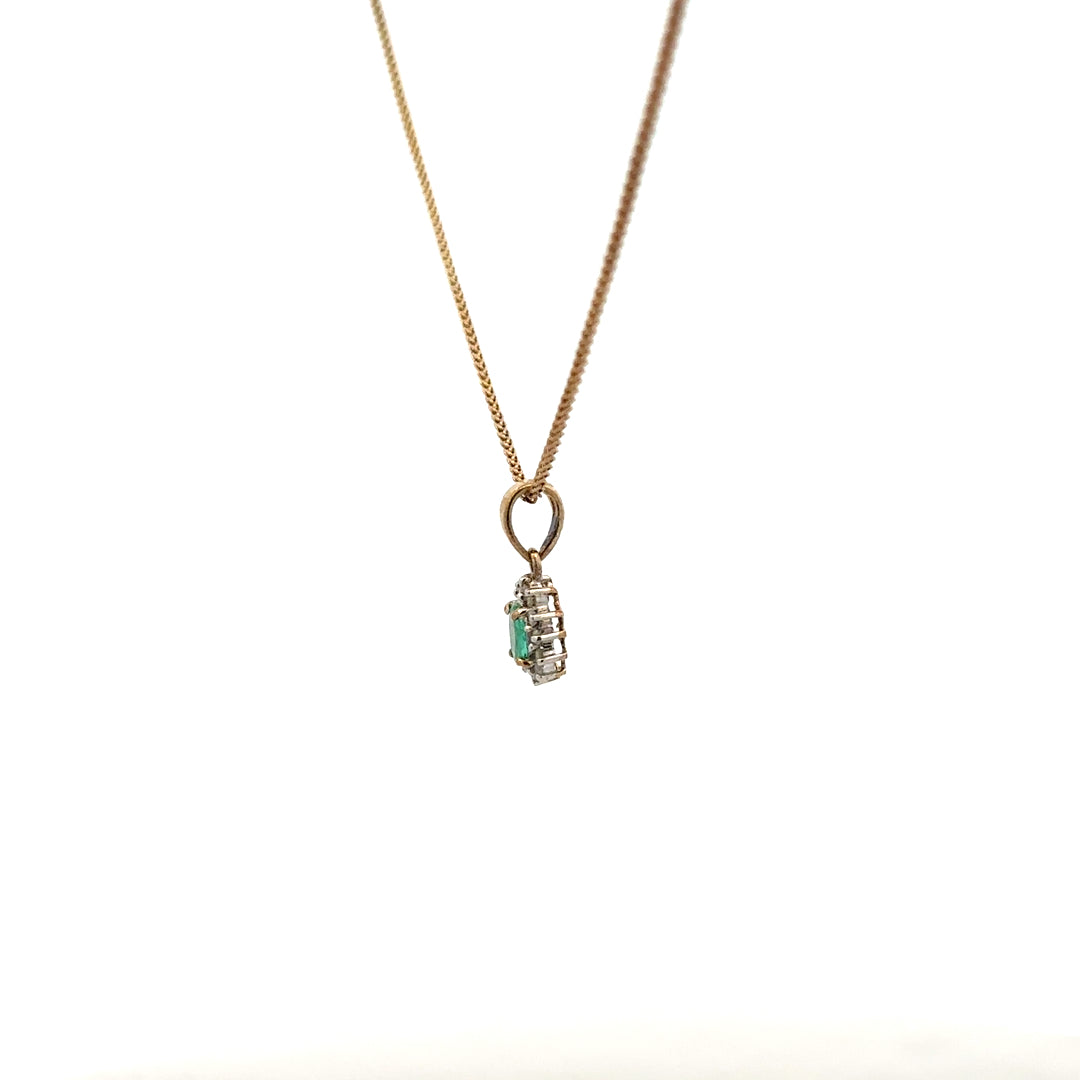 9ct yellow gold chain with emerald and diamond pendant, showcasing a delicate design and vibrant gemstones.