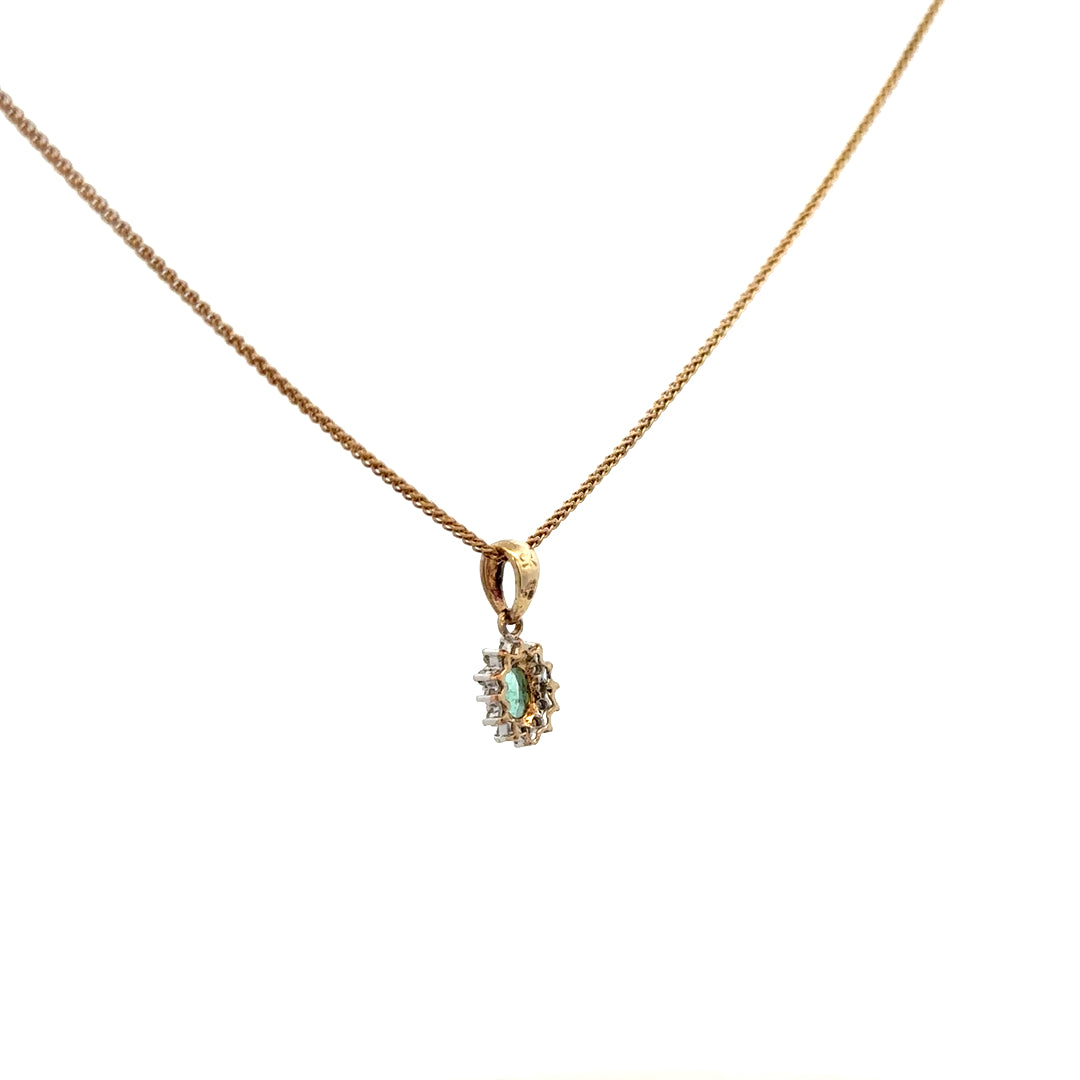 9ct yellow gold chain with emerald and diamond pendant, showcasing a delicate jewelry piece with vibrant green and sparkling stones.