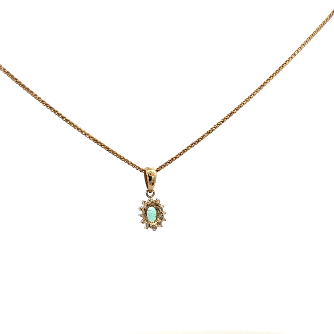 9ct yellow gold chain with emerald and diamond pendant, showcasing a detailed close-up of the jewelry design.