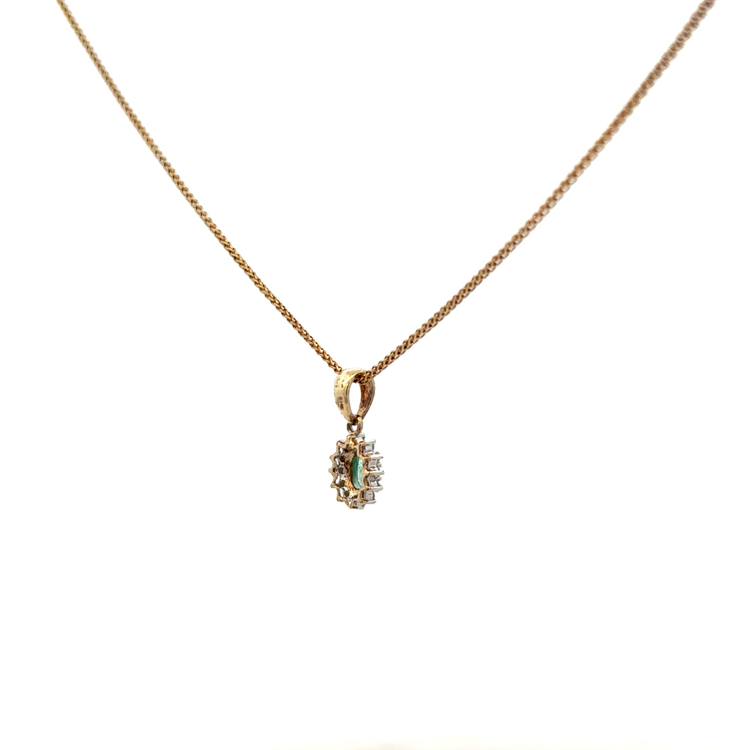 9ct yellow gold chain with emerald and diamond pendant, featuring a delicate design and sparkling gemstones.