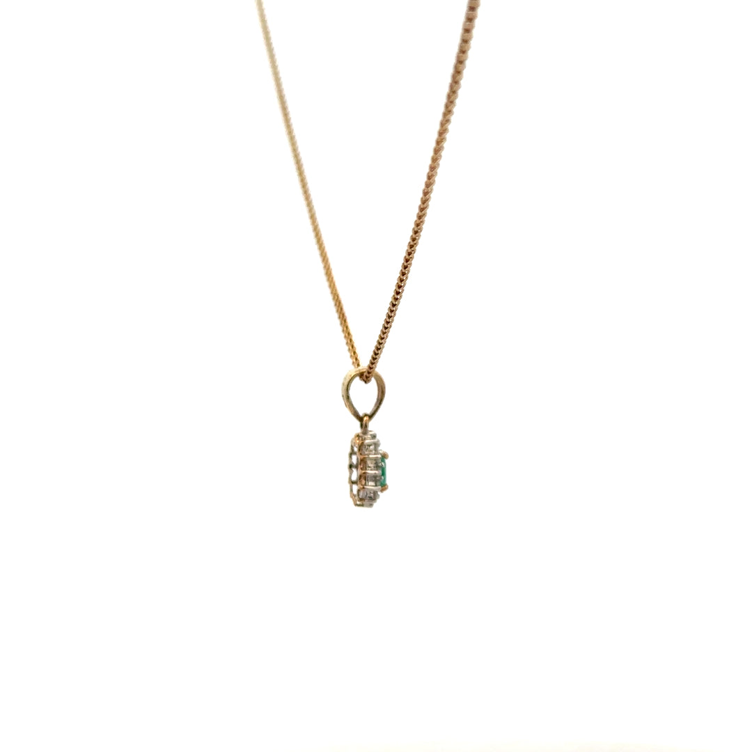 9ct yellow gold chain with emerald and diamond pendant, showcasing a delicate, elegant jewelry piece with vibrant gemstones.