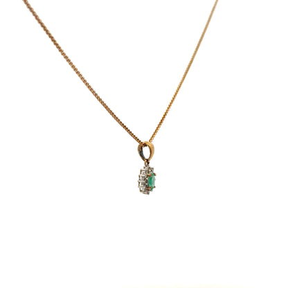 9ct yellow gold chain with emerald and diamond pendant, showcasing a delicate jewelry design and sparkling gemstones.