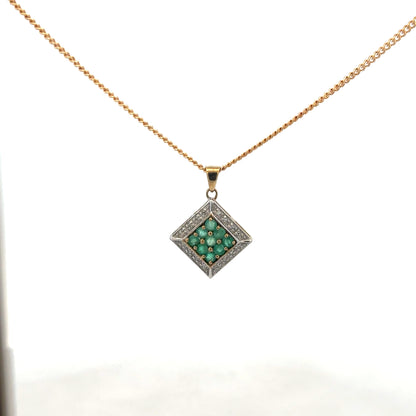 9ct yellow gold chain with emerald and diamond pendant, showcasing a delicate design and vibrant gemstones.