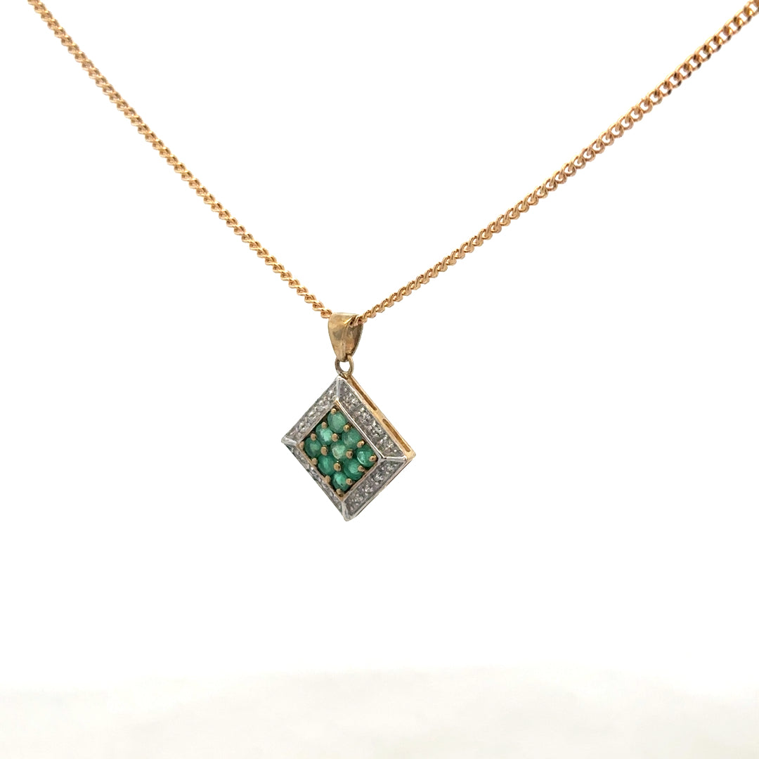 9ct yellow gold chain with emerald and diamond pendant, showcasing a delicate, elegant jewelry piece with vibrant gemstones.