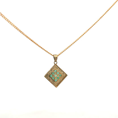9ct yellow gold chain with emerald and diamond pendant, showcasing a delicate jewelry design and vibrant gemstone accents.