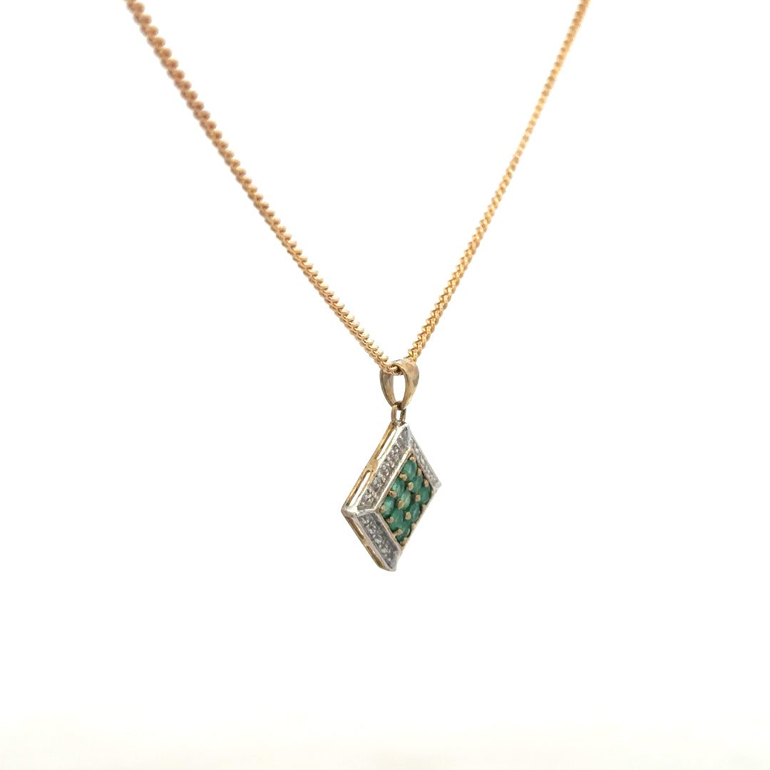 9ct yellow gold chain with emerald and diamond pendant, showcasing a delicate, elegant jewelry piece with vibrant green and sparkling gemstones.