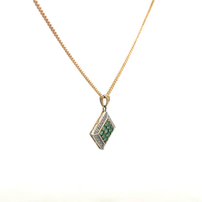 9ct yellow gold chain with emerald and diamond pendant, showcasing a delicate, elegant jewelry piece with vibrant green and sparkling gemstones.