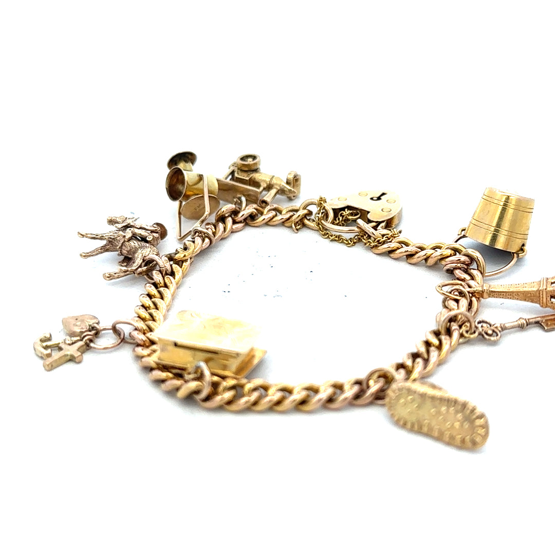 9ct yellow gold charm bracelet weighing 28.1g, featuring decorative charms and secure clasp, unbranded jewelry accessory.