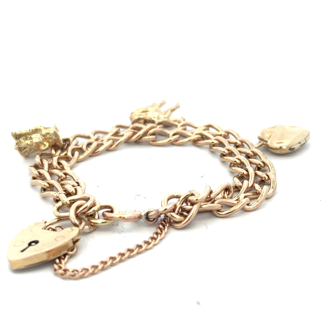 9ct yellow gold charm bracelet weighing 28.5g, featuring a delicate chain and decorative charms, unbranded jewelry accessory.