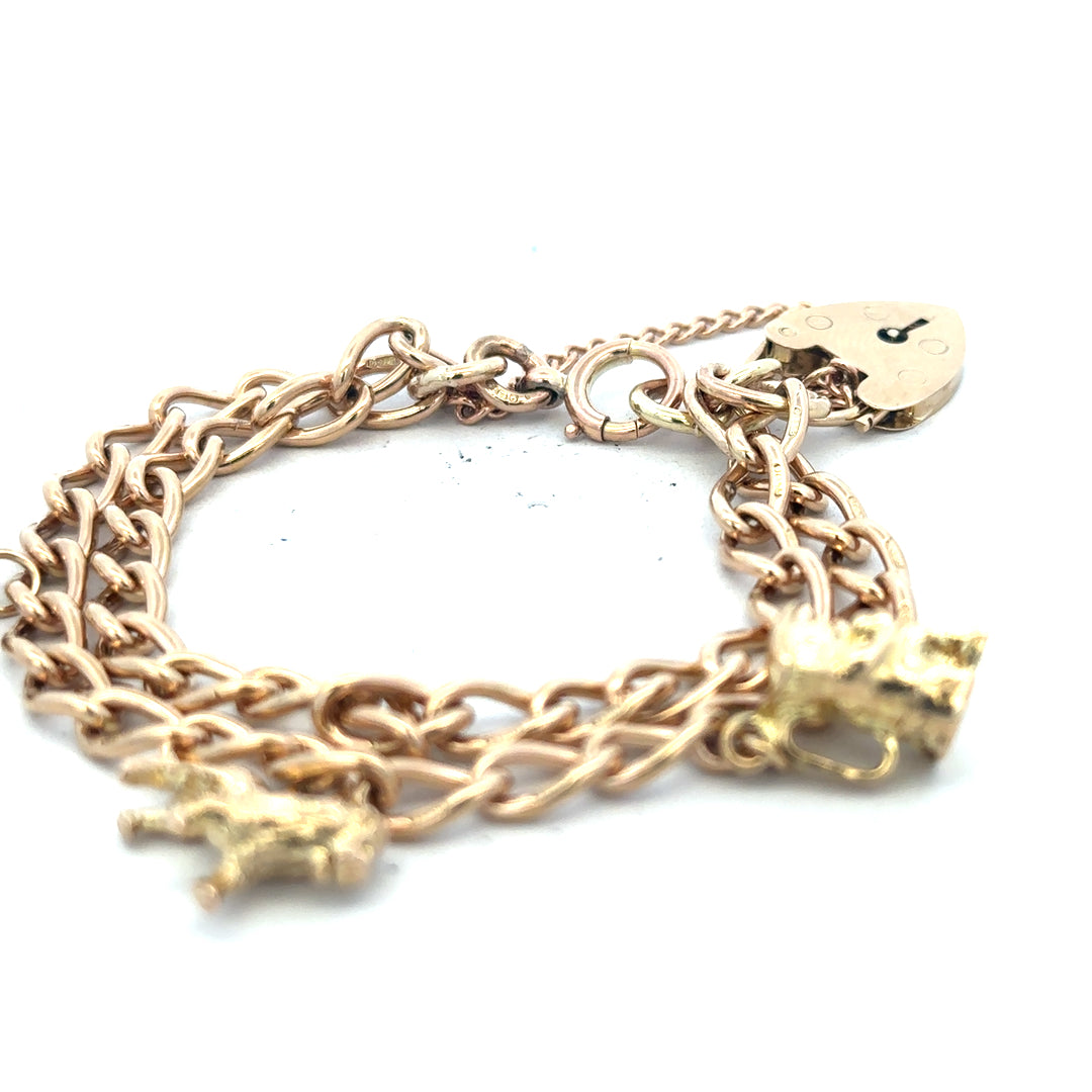 9ct yellow gold charm bracelet with intricate design, weighs 28.5g, showcasing a stylish and elegant jewelry piece.