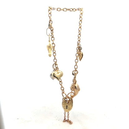 9ct yellow gold charm bracelet, 5.4g, with intricate charms and link design, crafted in unbranded jewelry style.