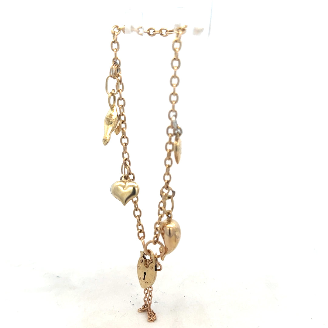 9ct yellow gold charm bracelet weighing 5.4g with decorative charms, unbranded, displayed on a neutral background.