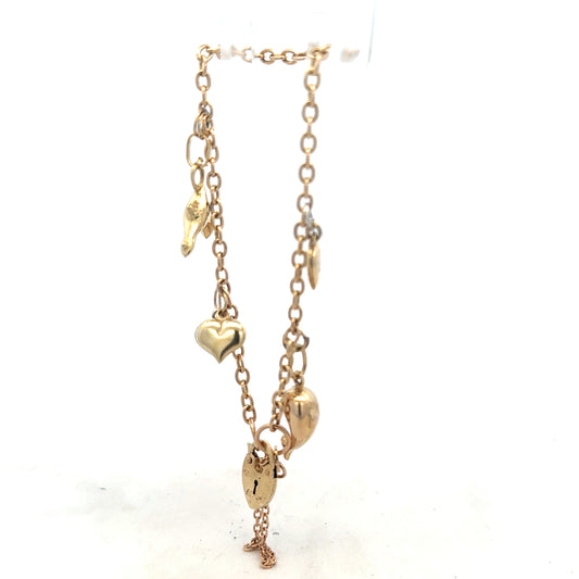 9ct yellow gold charm bracelet weighing 5.4g with decorative charms, unbranded, displayed on a neutral background.