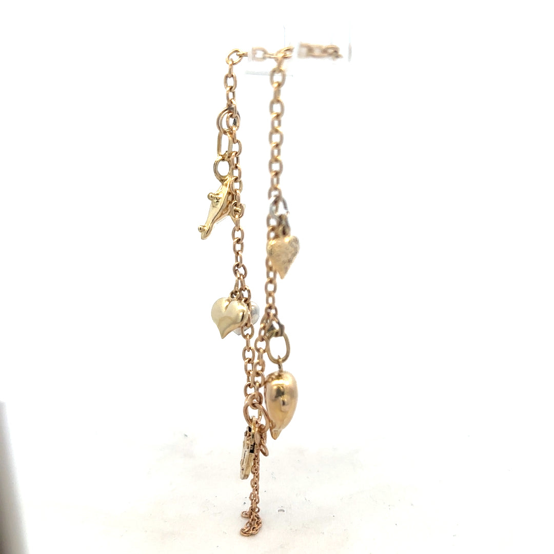 9ct yellow gold charm bracelet weighing 5.4g with intricate charms, crafted with fine gold detail.