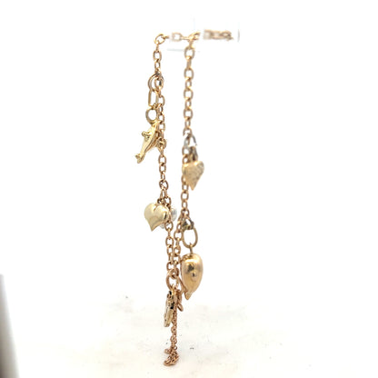 9ct yellow gold charm bracelet weighing 5.4g with intricate charms, crafted with fine gold detail.