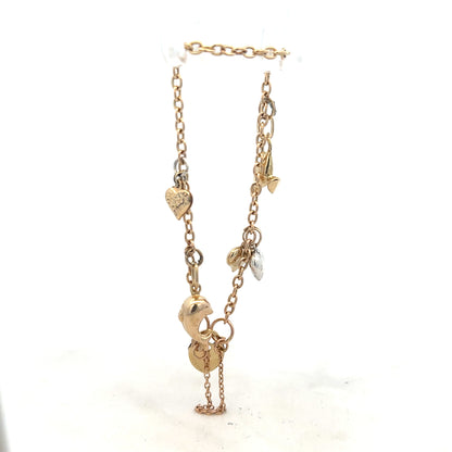 9ct yellow gold charm bracelet weighing 5.4g, featuring various decorative charms, unbranded jewelry accessory.