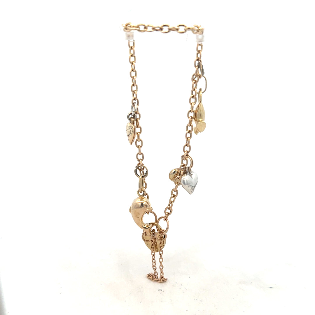 9ct yellow gold charm bracelet weighing 5.4g, featuring decorative charms on a delicate gold chain.