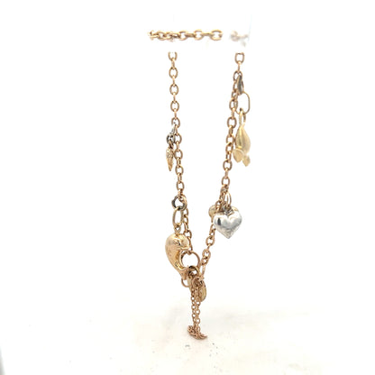 9ct yellow gold charm bracelet weighing 5.4g with decorative charms, unbranded, shown on a neutral background.