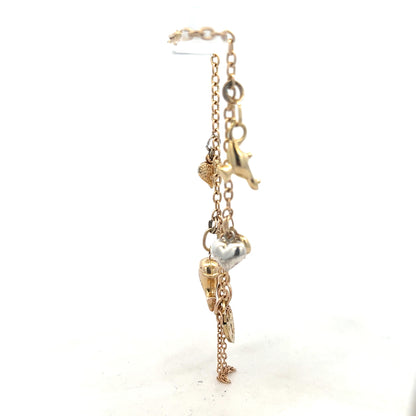 9ct yellow gold charm bracelet weighing 5.4g, unbranded jewelry with various decorative charms on a delicate chain.