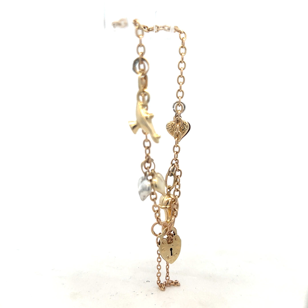 9ct yellow gold charm bracelet with intricate details, weighs 5.4g, featuring elegant gold charms and link design.
