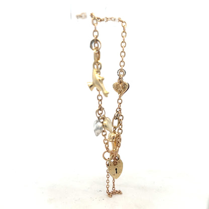 9ct yellow gold charm bracelet with intricate details, weighs 5.4g, featuring elegant gold charms and link design.