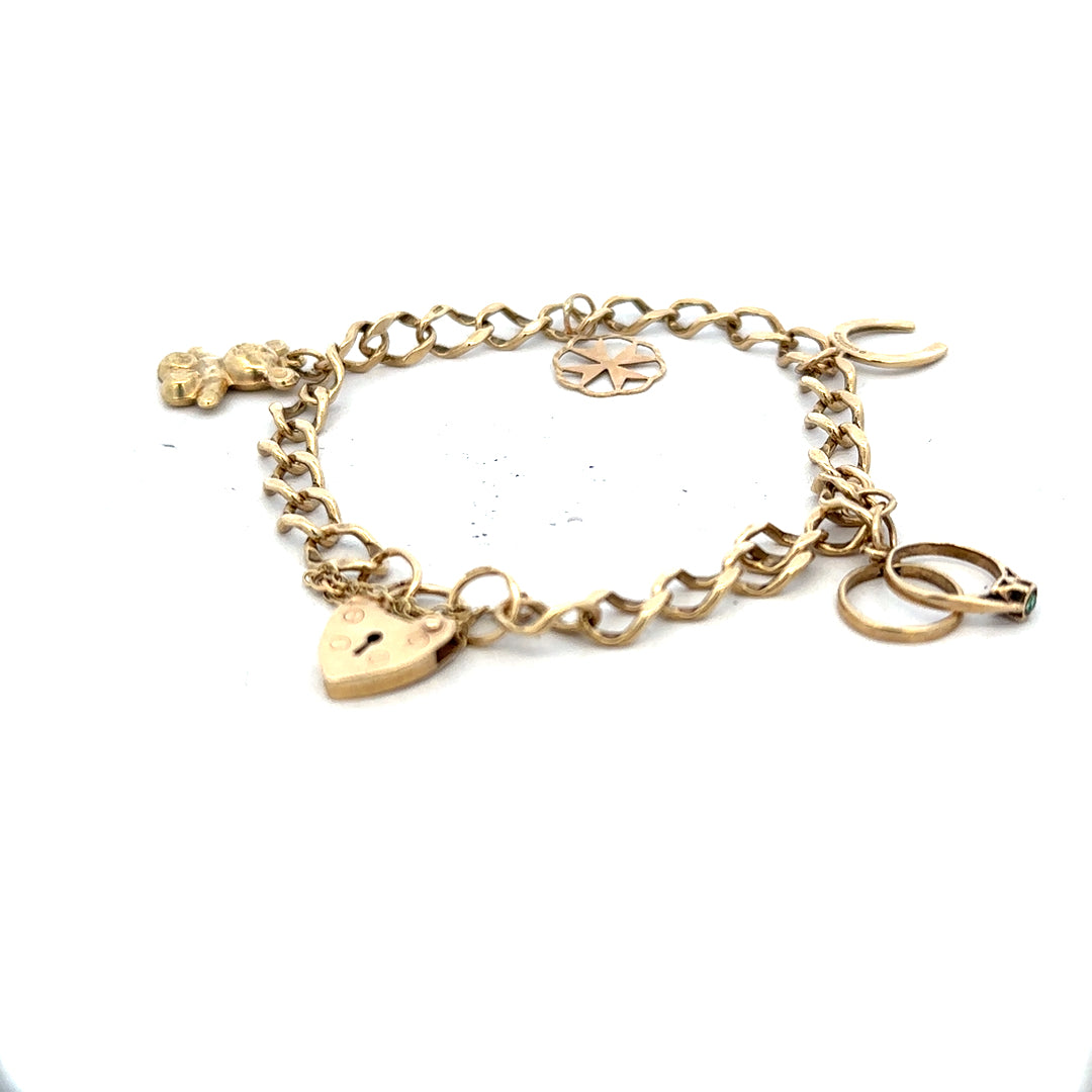9ct yellow gold charm bracelet weighing 9.9g with decorative charms, crafted in unbranded jewelry style.