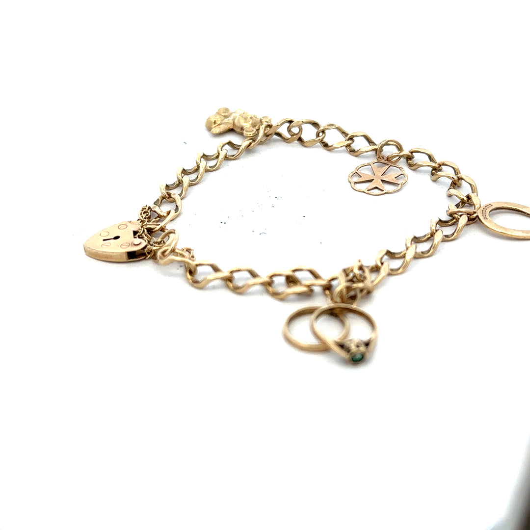 9ct yellow gold charm bracelet with intricate charms and clasp, weighs 9.9g, unbranded jewelry accessory for women
