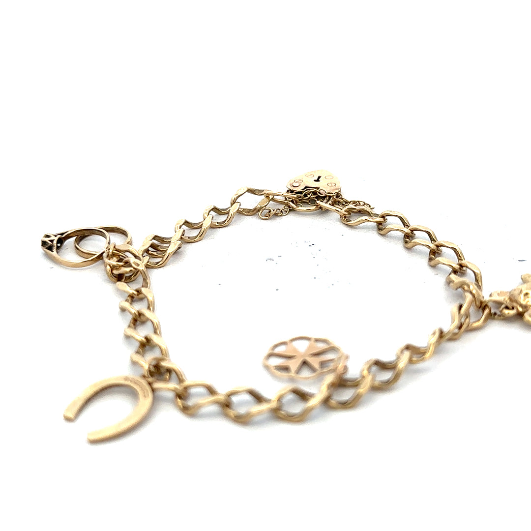 9ct yellow gold charm bracelet weighing 9.9g, featuring decorative charms, unbranded jewelry accessory, close-up view.