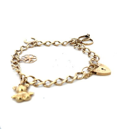 9ct yellow gold charm bracelet weighing 9.9g with detailed charms and links, unbranded jewelry showcasing elegant design