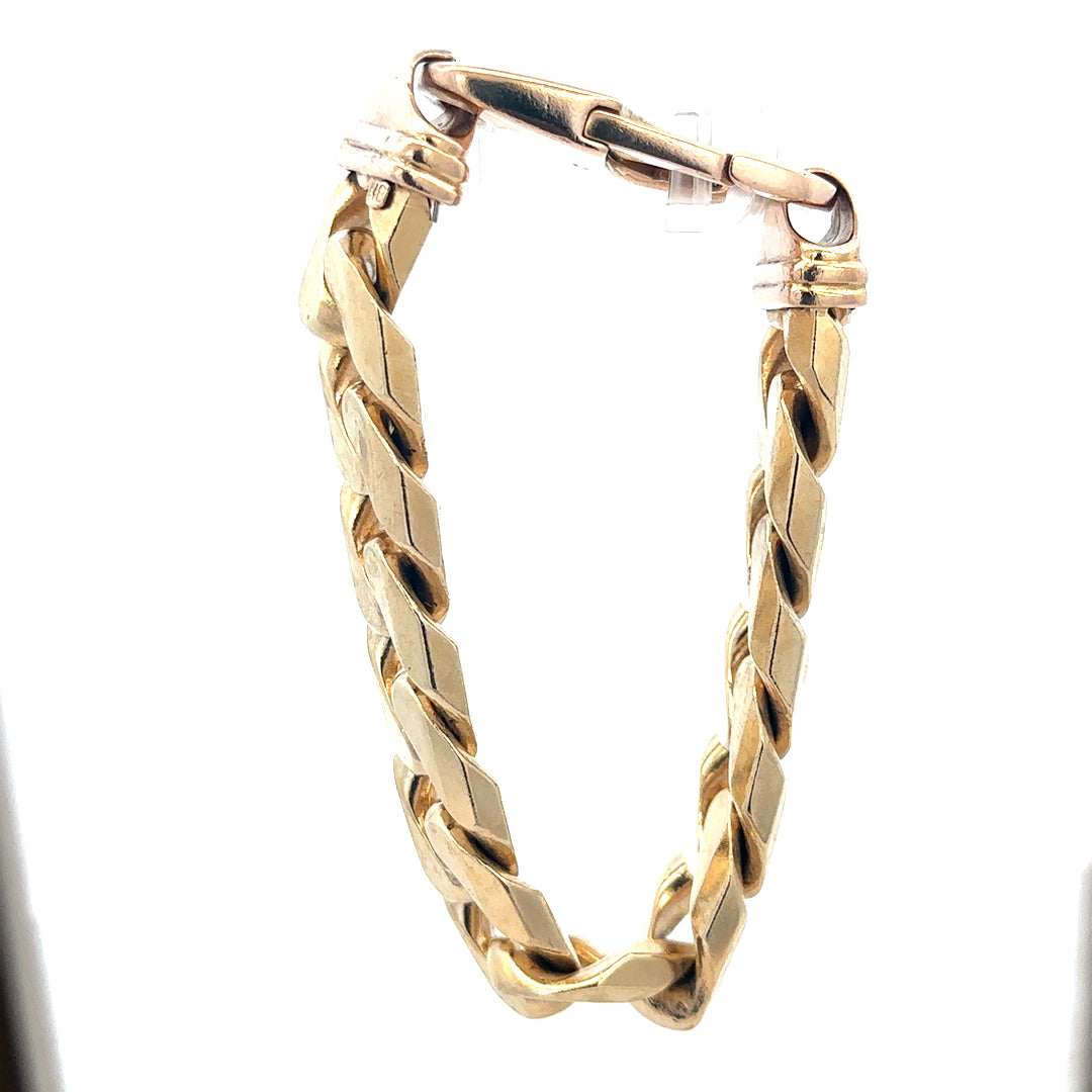 9ct yellow gold curb bracelet weighing 127g, featuring interlinked gold links, displayed on a plain background.