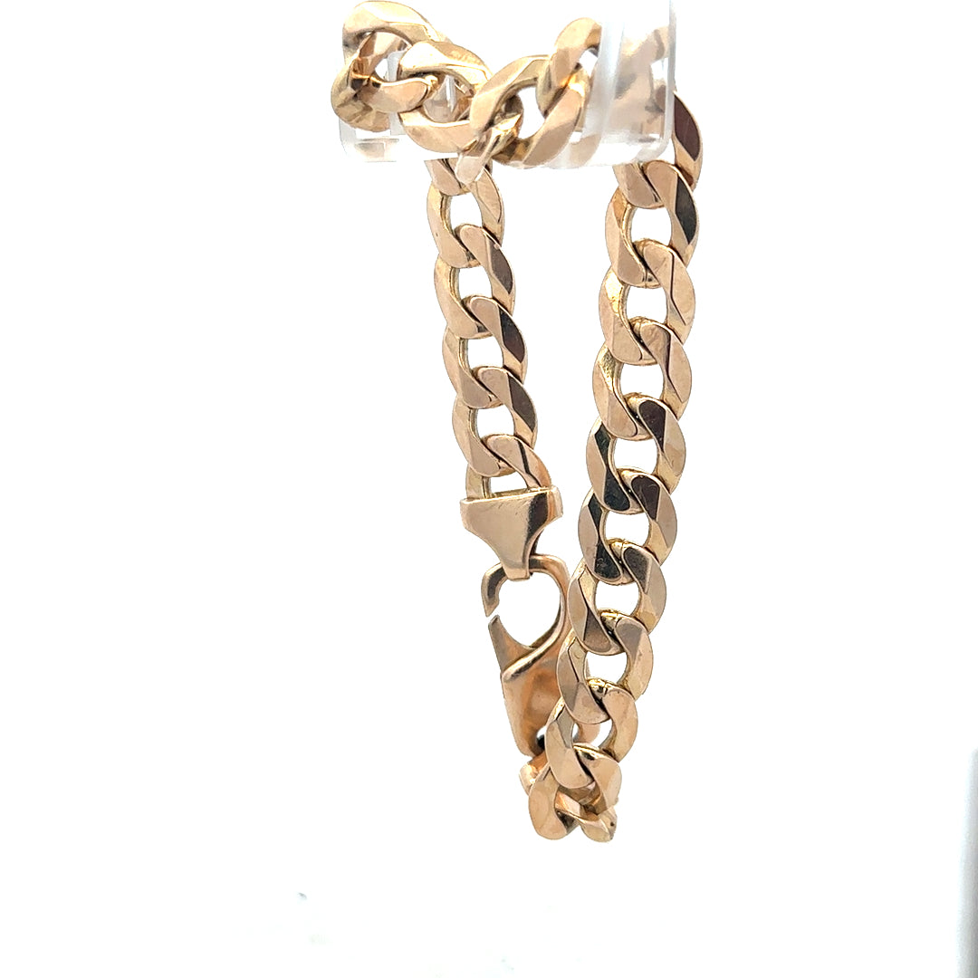 9ct yellow gold curb bracelet weighing 31.9g with a classic linked chain design and secure clasp.