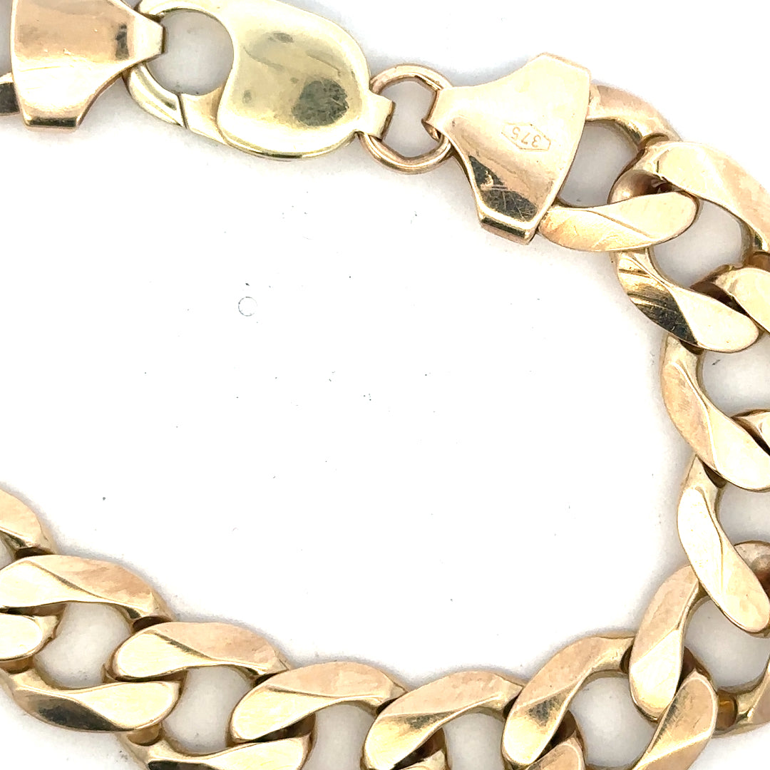 9ct yellow gold curb bracelet weighing 52.6g, featuring a classic chain design with a secure clasp.