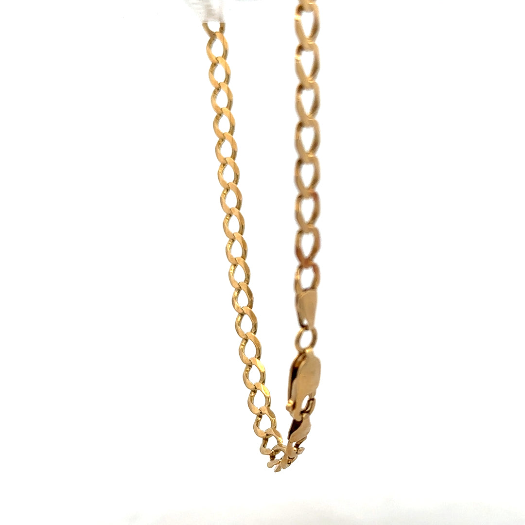 9ct yellow gold curb bracelet weighing 7.6g, showcasing a classic linked chain design on a neutral background.