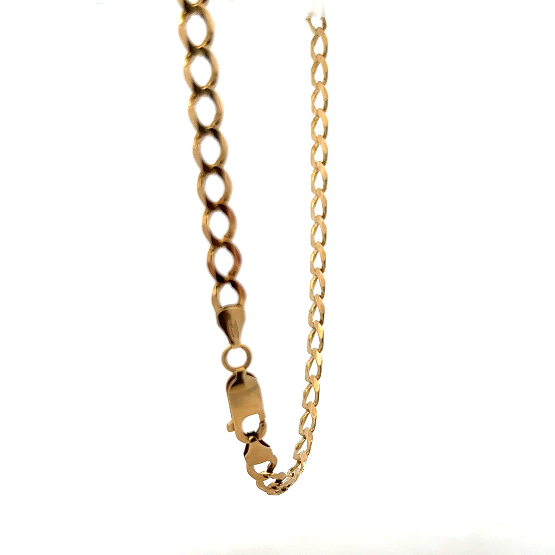 9ct yellow gold curb bracelet weighing 7.6g, featuring classic interlinked chain links in a close-up view.