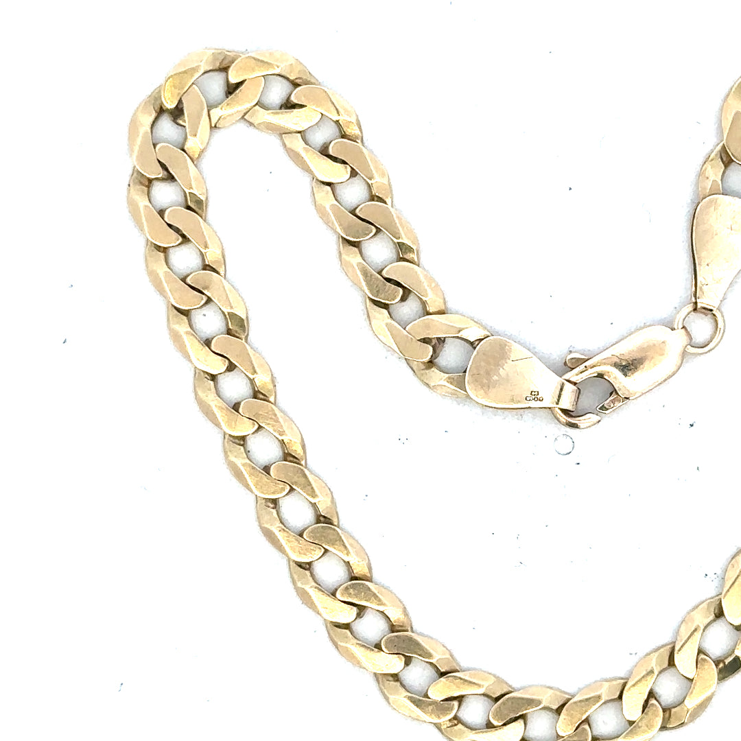 9ct yellow gold curb bracelet with 8.3g weight, showcasing a classic chain design on a plain background.