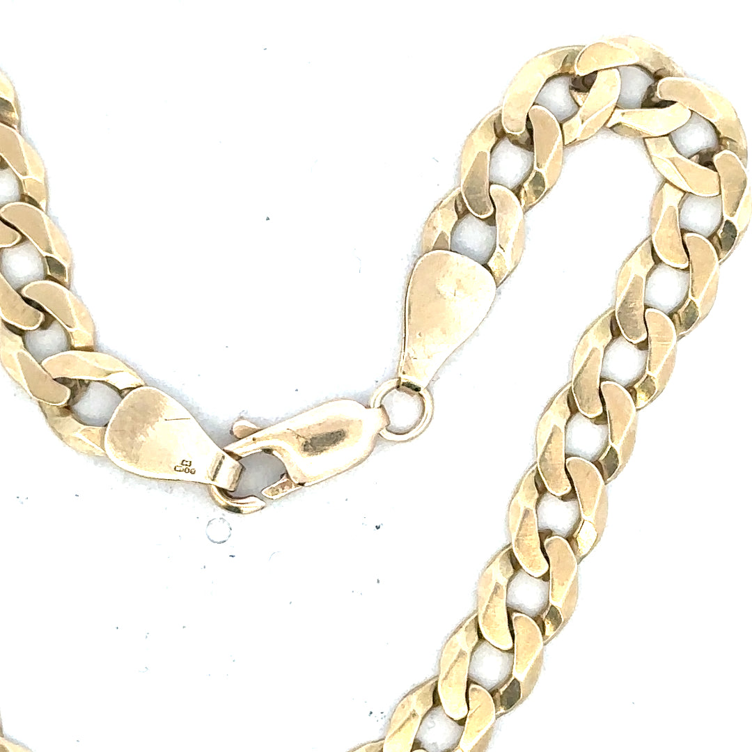 9ct yellow gold curb bracelet with a secure clasp, weighing 8.3 grams, featuring classic gold chain links.
