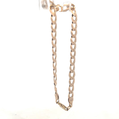 9ct yellow gold curb bracelet weighing 8.5g, featuring classic link design, unbranded jewelry piece with polished finish.