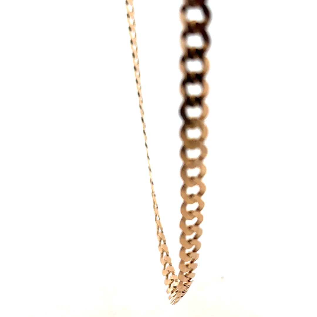 9ct yellow gold curb chain, unbranded, weighs 14.7g, featuring classic interlinked oval links, shown on a plain background.