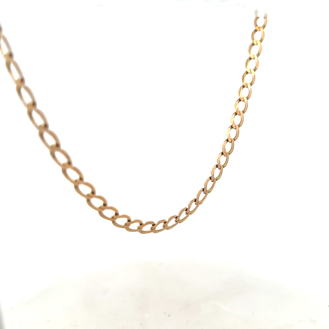 9ct yellow gold curb chain weighing 17.3g, unbranded jewelry with classic link design, shown in close-up detail.