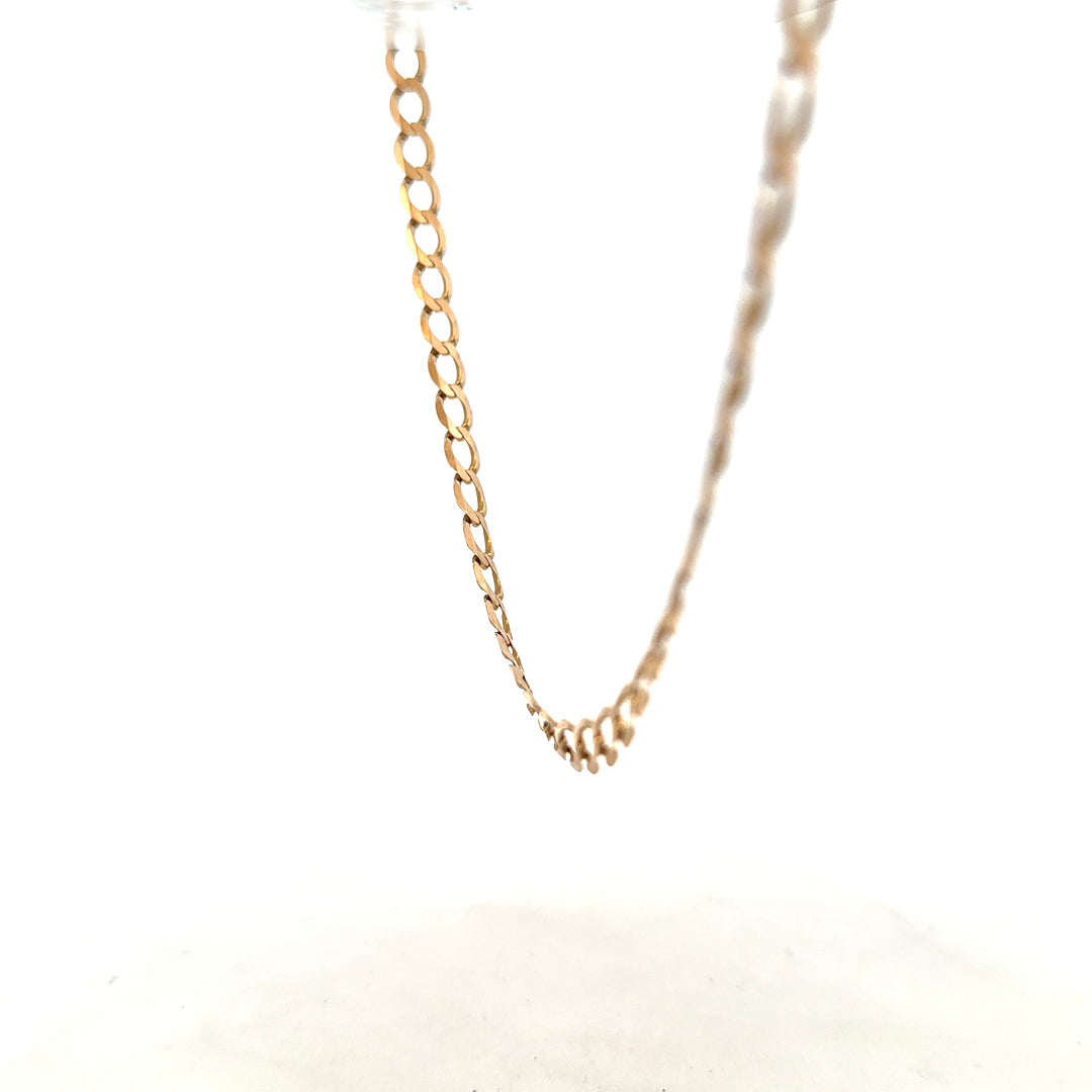 9ct yellow gold curb chain weighing 17.3g, with a classic design and secure clasp, showcased in natural lighting.