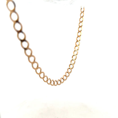 9ct yellow gold curb chain weighing 17.3g, close-up of the unbranded jewelry chain with interlocking links.