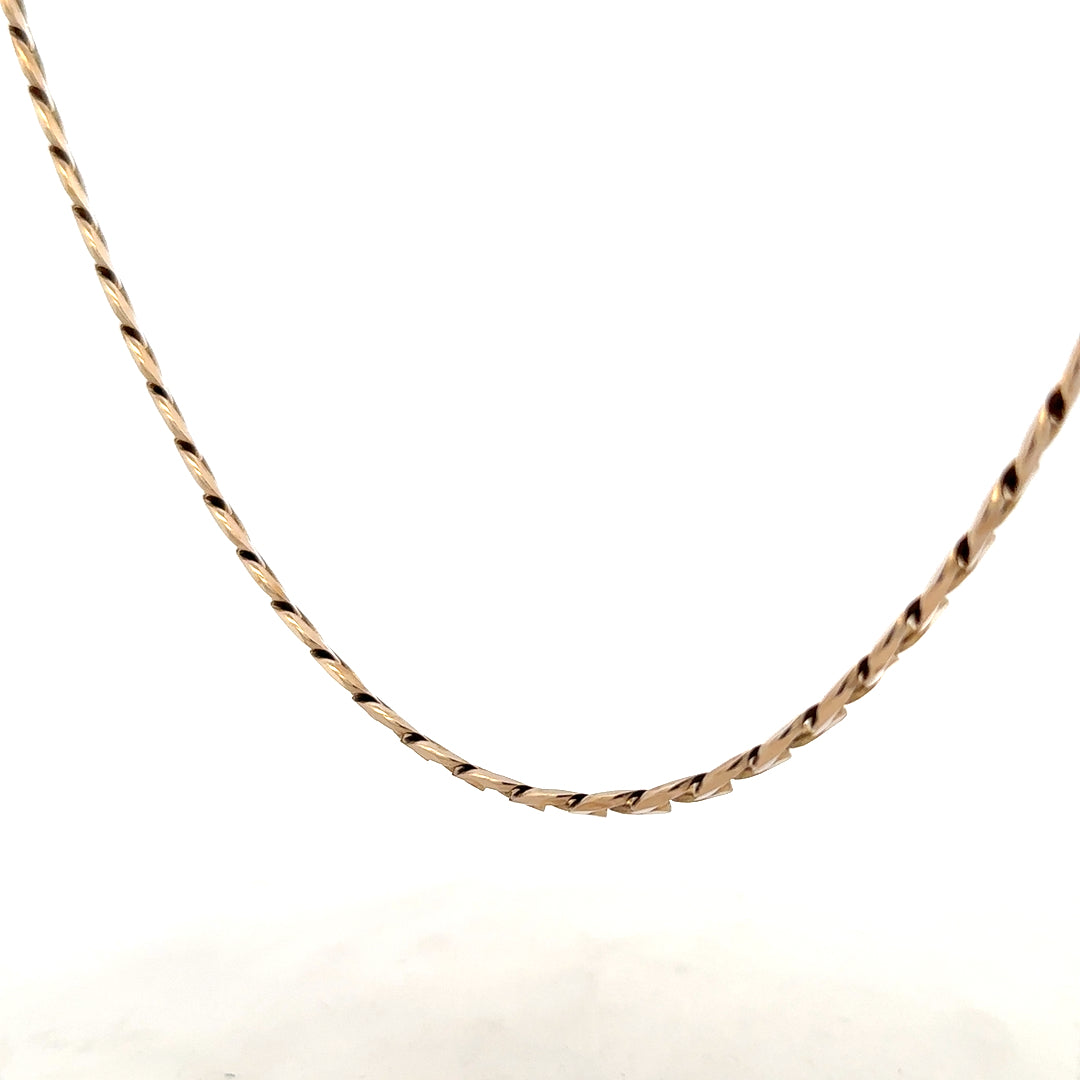 9ct yellow gold curb chain weighing 38.8g, close-up of the unbranded jewelry showing its links and polished finish.