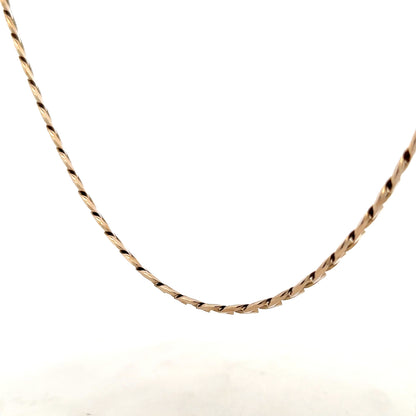 9ct yellow gold curb chain weighing 38.8g, close-up of the unbranded jewelry showing its links and polished finish.